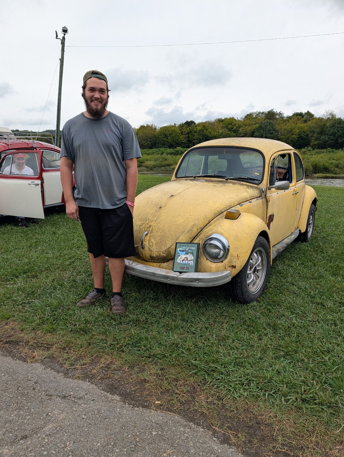 James Bryant standing beside his classic Volkswagen
