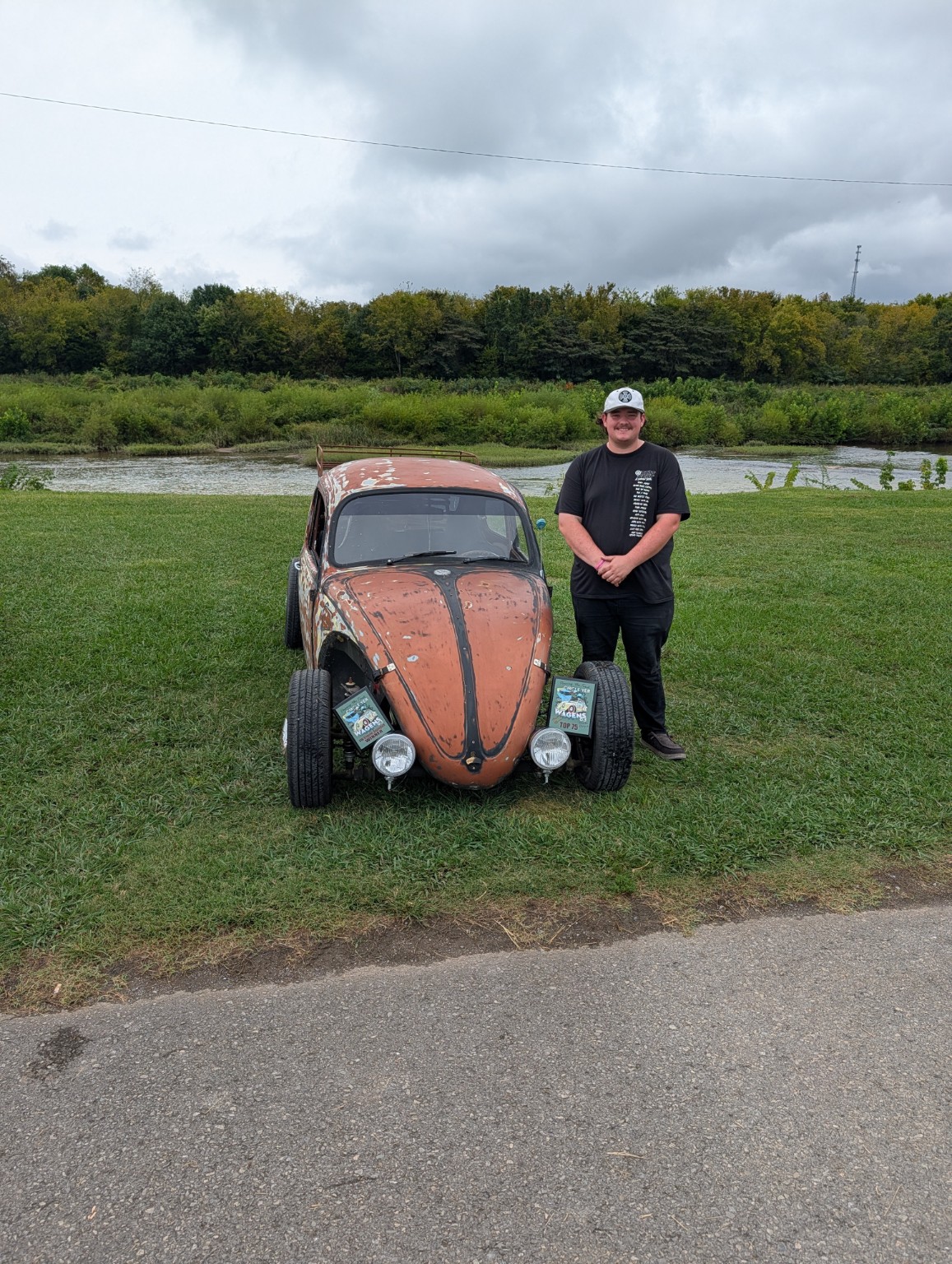 Sam Maxwell standing beside his classic Volkswagen